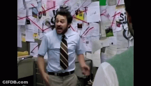 Man In Blue Shirt And Tie By Wall With Papers GIF
