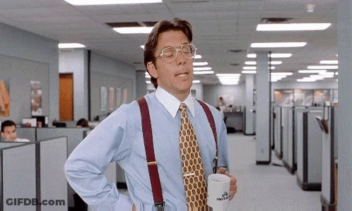 Man In Blue Shirt And Tie Holding Coffee In Office GIF