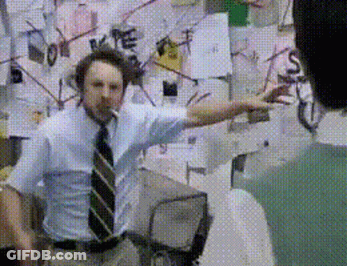 Man In Blue Shirt And Tie In Front Of Wall With Love GIF