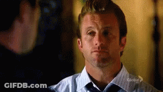 Man In Blue Shirt And Tie Looking At Man In Black Shirt GIF