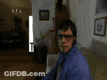 Man In Blue Shirt And Tie Standing In Dark Room With T GIF