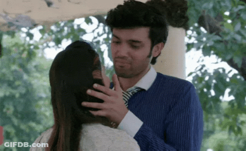 Man In Blue Shirt And Tie Touching Woman's Head GIF