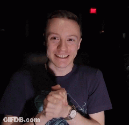 Man In Blue Shirt And Watch Smiling With Folded Hands GIF