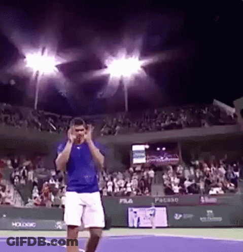 Man In Blue Shirt And White Shorts On Tennis Court GIF