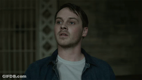 Man In Blue Shirt And White T-Shirt Looks Up GIF