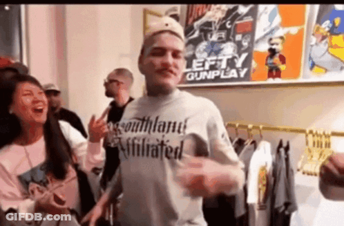 Man In Blue Shirt At Mic Saying To The Left GIF