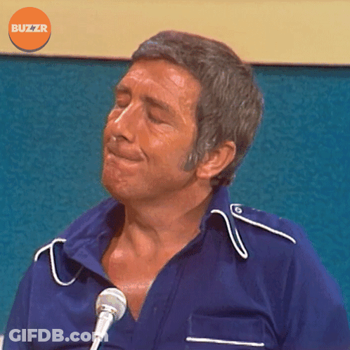 Man In Blue Shirt At Microphone With Buzzr Logo GIF