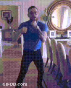 Man In Blue Shirt Boxing In Living Room GIF