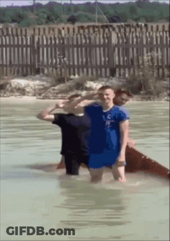 Man In Blue Shirt C Standing In Water GIF