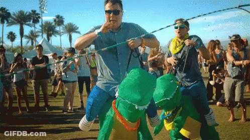 Man In Blue Shirt Carrying Dinosaurs GIF