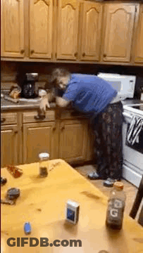 Man In Blue Shirt Cleaning Kitchen Cabinet GIF