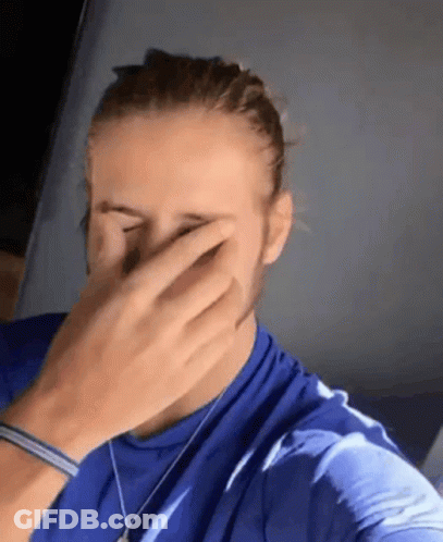 Man In Blue Shirt Covering Face With Hands GIF