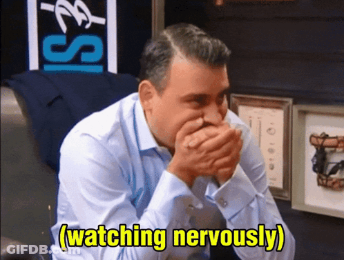 Man In Blue Shirt Covering Mouth GIF
