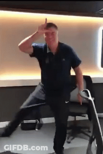 Man In Blue Shirt Dancing And Flipping Off GIF
