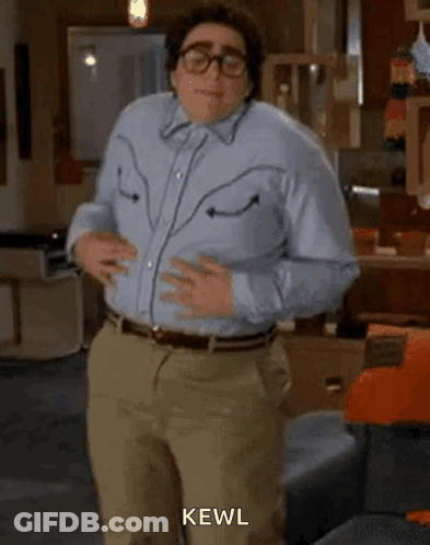 Man In Blue Shirt Dancing In Living Room With Glasses GIF