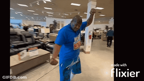 Man In Blue Shirt Dancing In Store With Flixier GIF