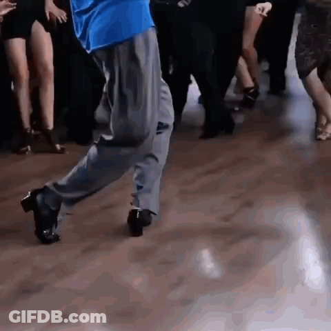 Man In Blue Shirt Dancing On Wooden Floor GIF