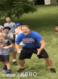 Man In Blue Shirt Dancing With Children GIF