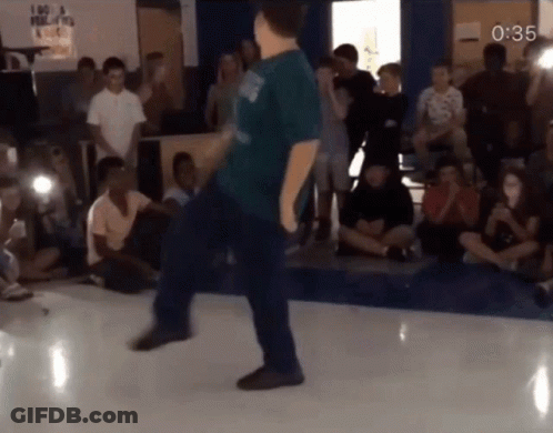 Man In Blue Shirt Dancing With Sign I Am A Filipino GIF