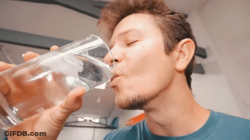 Man In Blue Shirt Drinking From Glass GIF