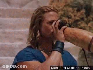 Man In Blue Shirt Drinking From Long Horn GIF