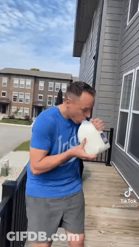 Man In Blue Shirt Drinking Milk From Pitcher GIF