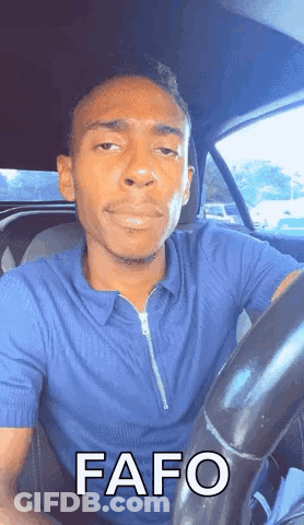Man In Blue Shirt Driving Car With Funny Face GIF
