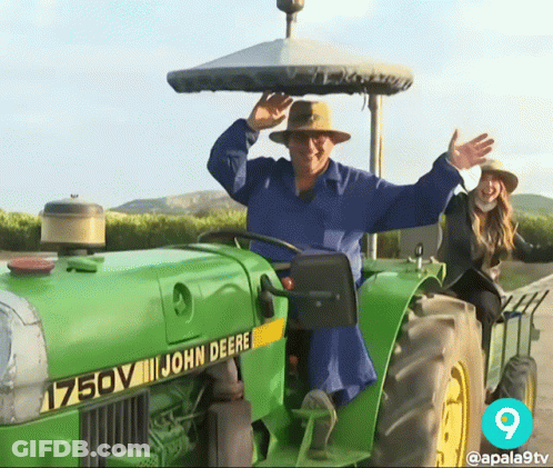 Man In Blue Shirt Driving John Deere Tractor GIF