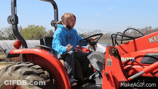 Man In Blue Shirt Driving Red Kubota Tractor GIF