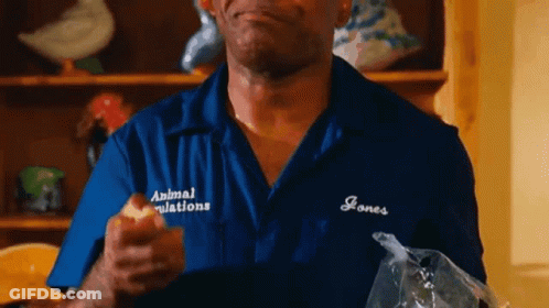Man In Blue Shirt Eating Apple Holding Food Bag GIF