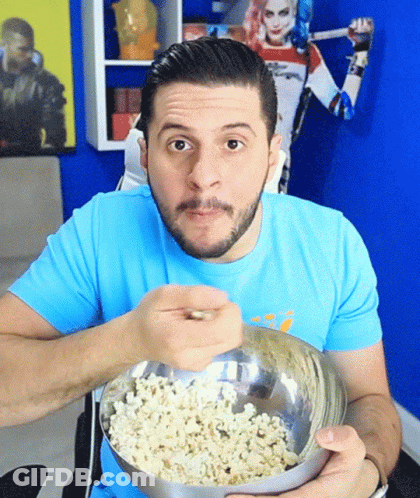 Man In Blue Shirt Eating Popcorn GIF
