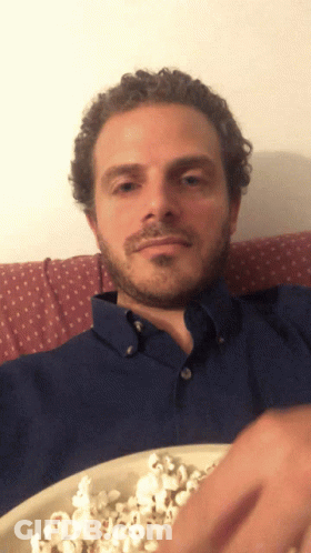 Man In Blue Shirt Eating Popcorn GIF