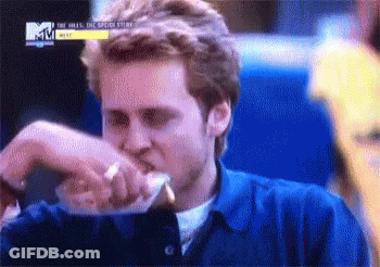 Man In Blue Shirt Eating Sandwich GIF