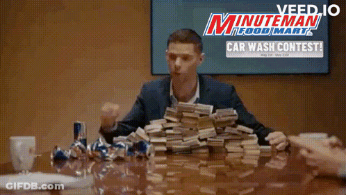 Man In Blue Shirt Flexing Muscles Sitting On Ground GIF
