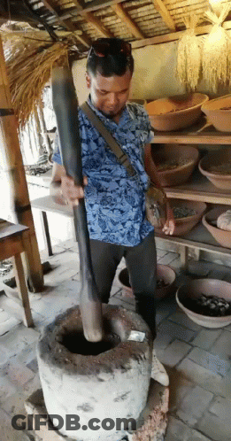 Man In Blue Shirt Grinding With Wooden Stick GIF