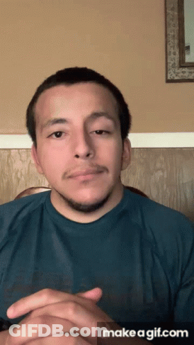 Man In Blue Shirt Hands Folded Saying Make A GIF