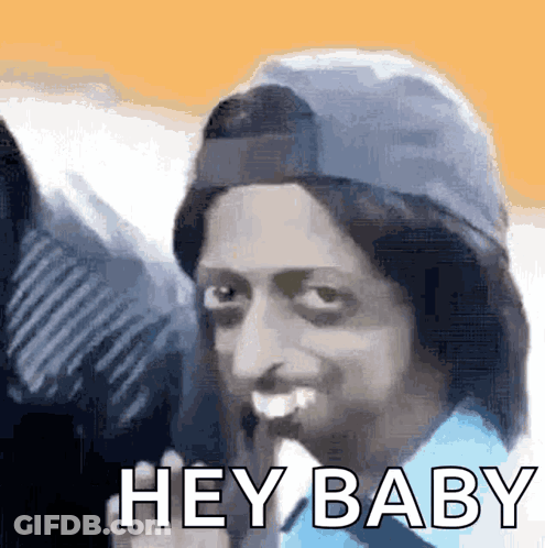 Man In Blue Shirt Holding Banana Says Hey Baby GIF