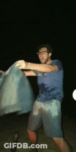 Man In Blue Shirt Holding Blue Cloth GIF