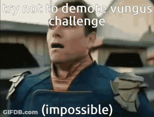 Man In Blue Shirt Holding Book Says Try Not To Demote Vungus Challenge Impossible GIF