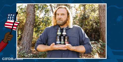 Man In Blue Shirt Holding Bottles With American Flag Hand GIF