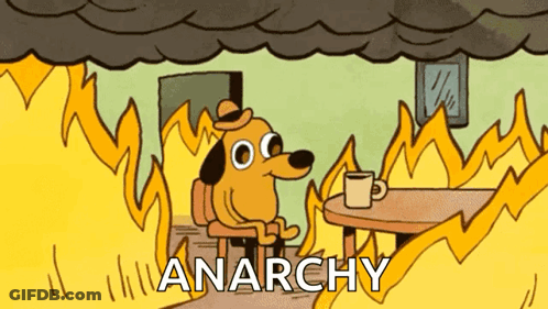 Man In Blue Shirt Holding Chainsaw And Gun GIF