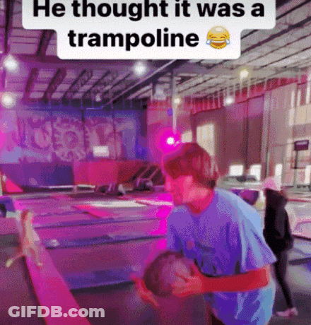 Man In Blue Shirt Holding Child On Trampoline Saying He Thought It Was A Trampoline GIF