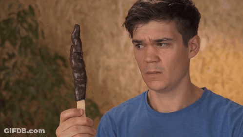 Man In Blue Shirt Holding Chocolate Ice Cream Stick GIF