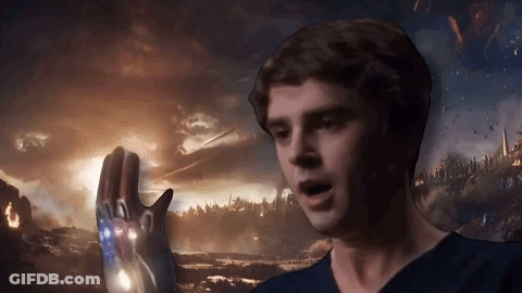 Man In Blue Shirt Holding Glowing Iron Man Glove GIF