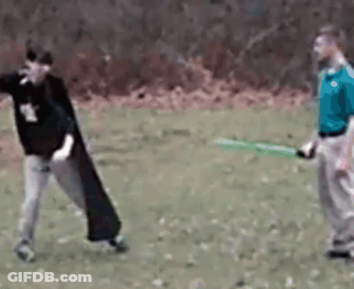 Man In Blue Shirt Holding Green Sword GIF