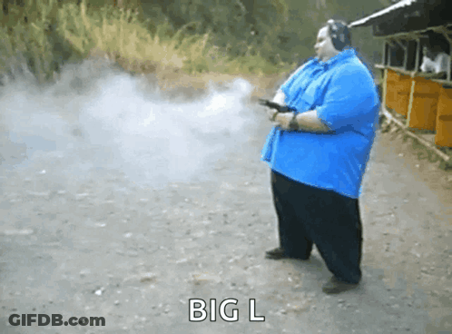 Man In Blue Shirt Holding Gun GIF