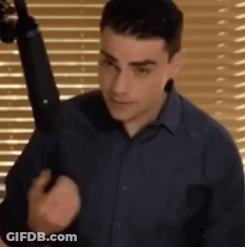 Man In Blue Shirt Holding Gun GIF