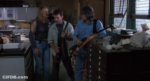 Man In Blue Shirt Holding Gun GIF