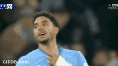Man In Blue Shirt Holding Hand To Face GIF