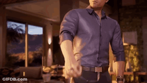 Man In Blue Shirt Holding Hand GIF